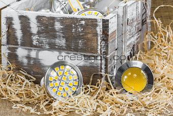 GU10 LED bulbs on straw in front of old  box