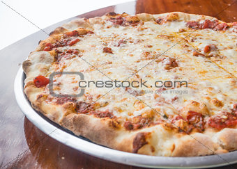 Fresh and hot cheese pizza served on wooden table 