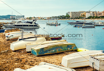 Old boats on the empty beach of Ibiza.  Balearic Islands, Spain