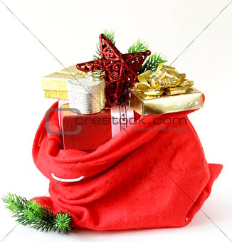 red bag full of Christmas gifts, boxes and decorations