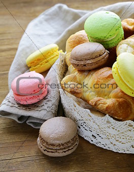 traditional French pastries croissants and macaroons in a lace basket