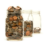 Three glass jars filled with American coins