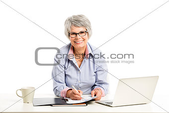 Ellderly woman working with a laptop