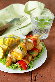 chicken kebabs with vegetables on wooden skewers