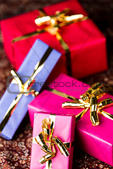 Four Wrapped Gifts with Golden Bows