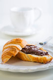 Breakfast with croissant and chocolate.