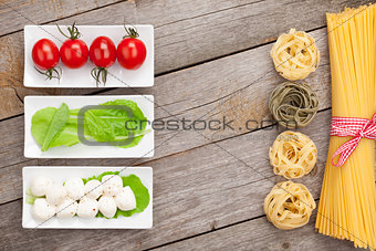 Tomatoes, mozzarella, pasta and green salad leaves