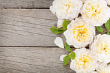 Wooden background with fresh rose flowers