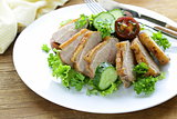salad with grilled duck fillet, tomato and green lettuce