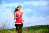 Young Beautiful Woman Running on Mountain Trail in the Morning