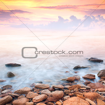 beautiful sunrise over the rocky sea coast