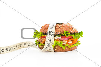 Sandwich with measuring tape. Fitness concept.
