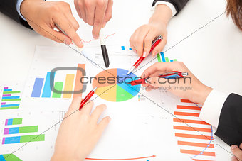 business people looking at report and analyzing chart
