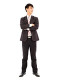 smiling businessman standing and crossed arms over white