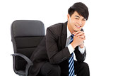smiling Young businessman sitting on a chair