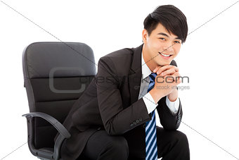 smiling Young businessman sitting on a chair