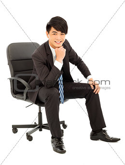 Young smart business man sitting in a chair