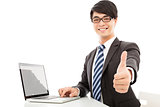 smiling  man using laptop and thumb up