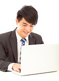 closeup of happy young business man using a laptop 