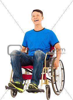 hopeful young man sitting on a wheelchair in studio