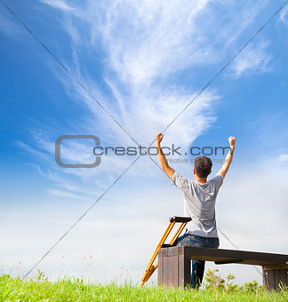 Injured Man raise hands and  sitting on a bench with Crutches