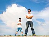 Asian father and son standing on a stone platform 