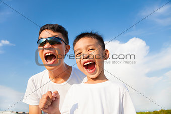 closeup of father and son are shouting in outdoors