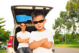 cool boy and father across arms with their car 