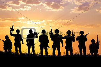 silhouette of  Soldiers team with sunrise background 