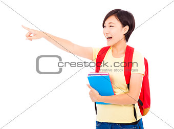 happy student girl holding books and pointing