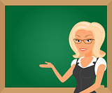 Blonde teacher showing something on green board.