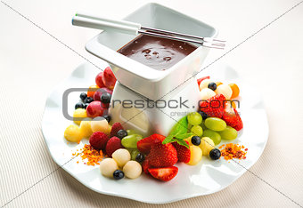 Chocolate fondue with fresh fruits and berries
