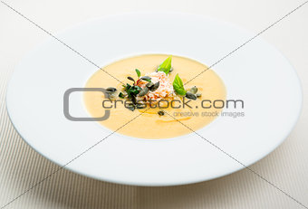 Pumpkin crab soup on a white bowl