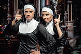 Attractive young nuns posing in the church
