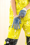 Female construction worker in coverall and protective gloves