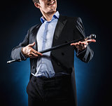 Man in elegant black jacket and blue shirt holding cane