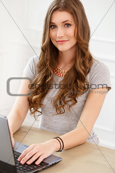 Student. Attractive girl by the table