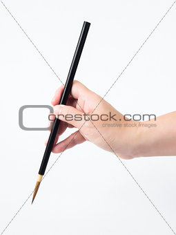 Woman hand and black brush