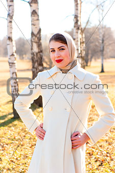 young woman in white coat outdoors