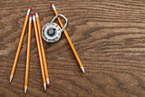 Pencils and lock on wood surface