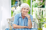 Senior woman sitting at home