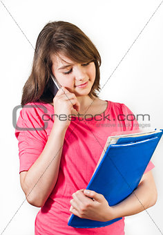 Attractive teenage girl talking on the phone. All on white background