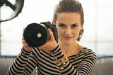 Portrait of young woman with modern dslr photo camera