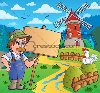 Farmer with sign near windmill