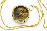 Old style gold compass with chain on white background