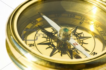 Old style gold compass on white background