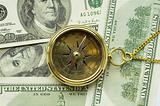 Old style gold compass with chain on dollar background