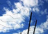 Barbed wire on blue sky