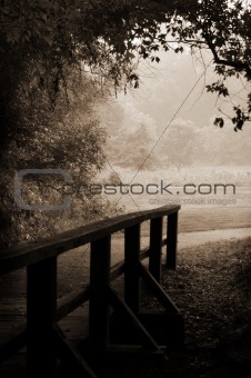 Sepia-toned wooden bridge and path