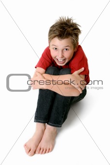 Sitting child in jeans and t-shirt